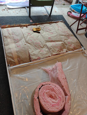 frame with insulation one wooden flat, on the floor, with fiberglass insulation affixed to the inside.